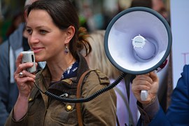 woman holding speaker